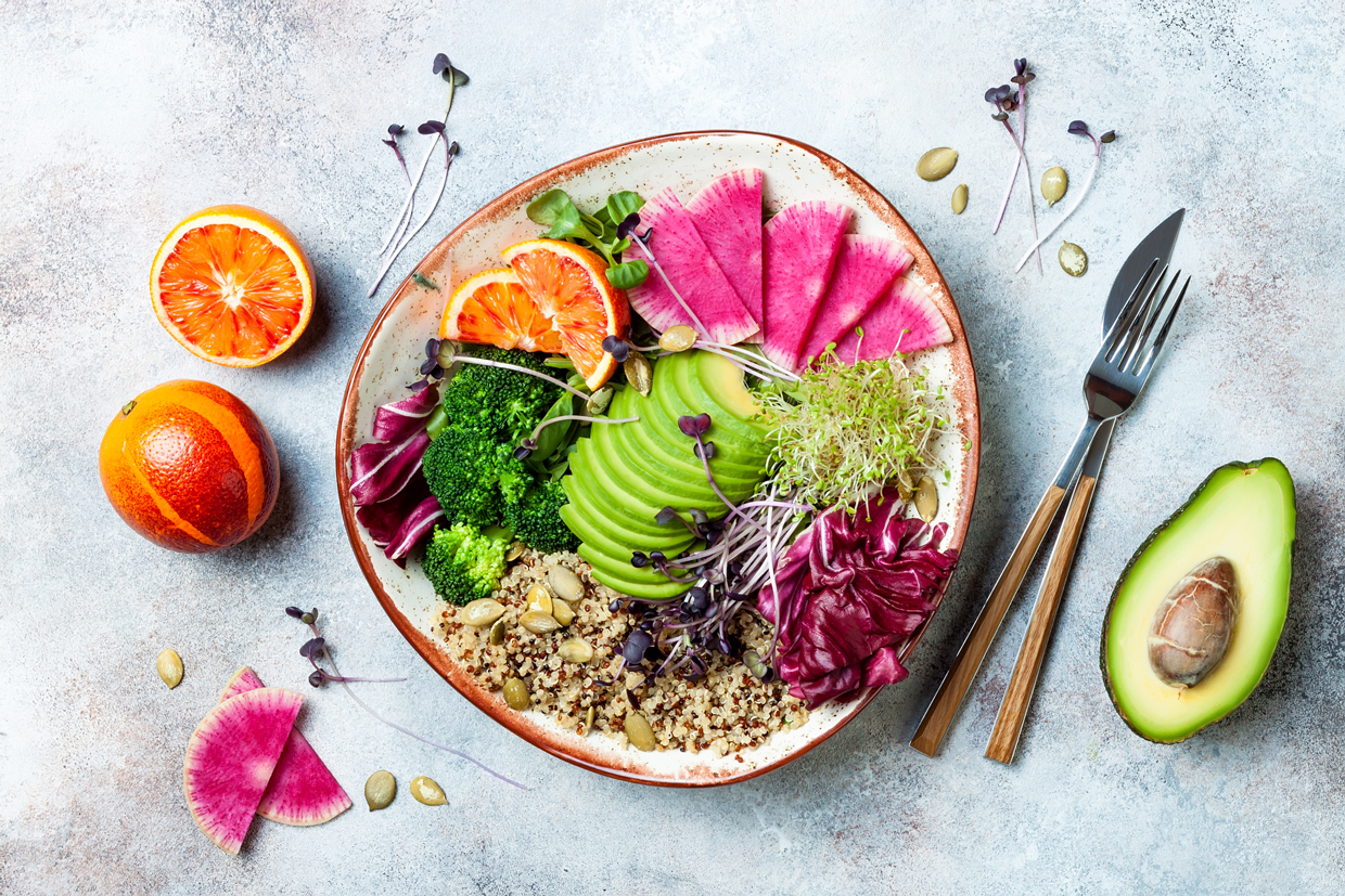 Buddha bowl with quinoa, micro greens, avocado, blood orange, broccoli, watermelon radish, alfalfa seed sprouts