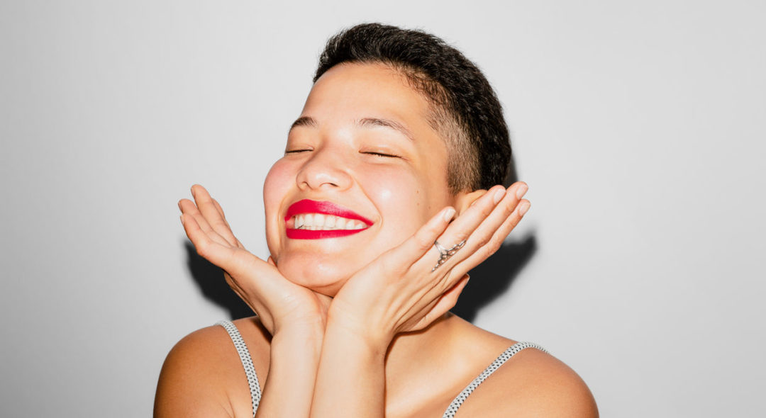 Woman smiling with her eyes closed