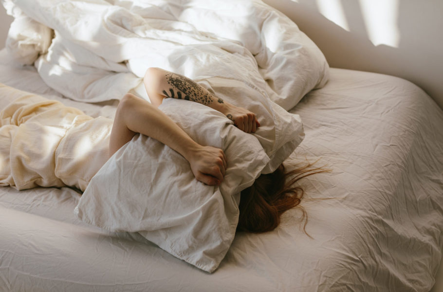 Exhausted woman in bed