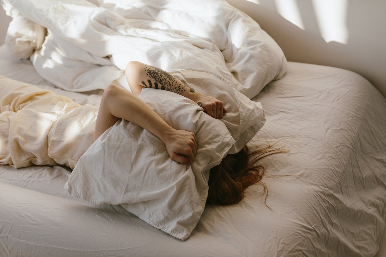 Exhausted woman in bed