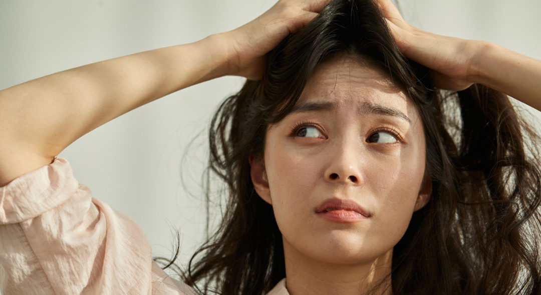 woman scratching scalp
