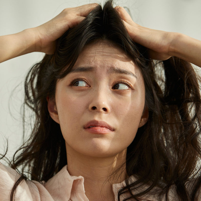 woman scratching scalp