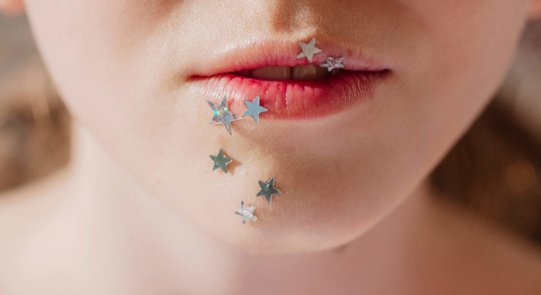 Crop photo of lips with silver stars make up