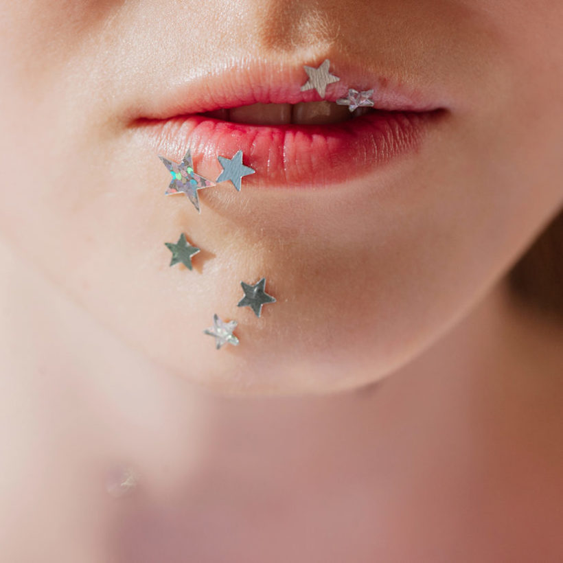 Crop photo of lips with silver stars make up