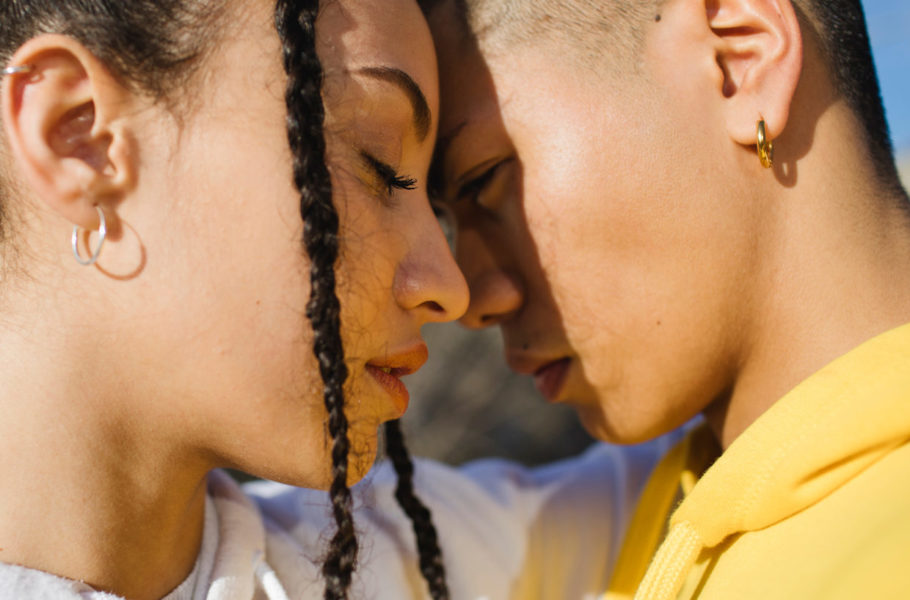two women faces touching together