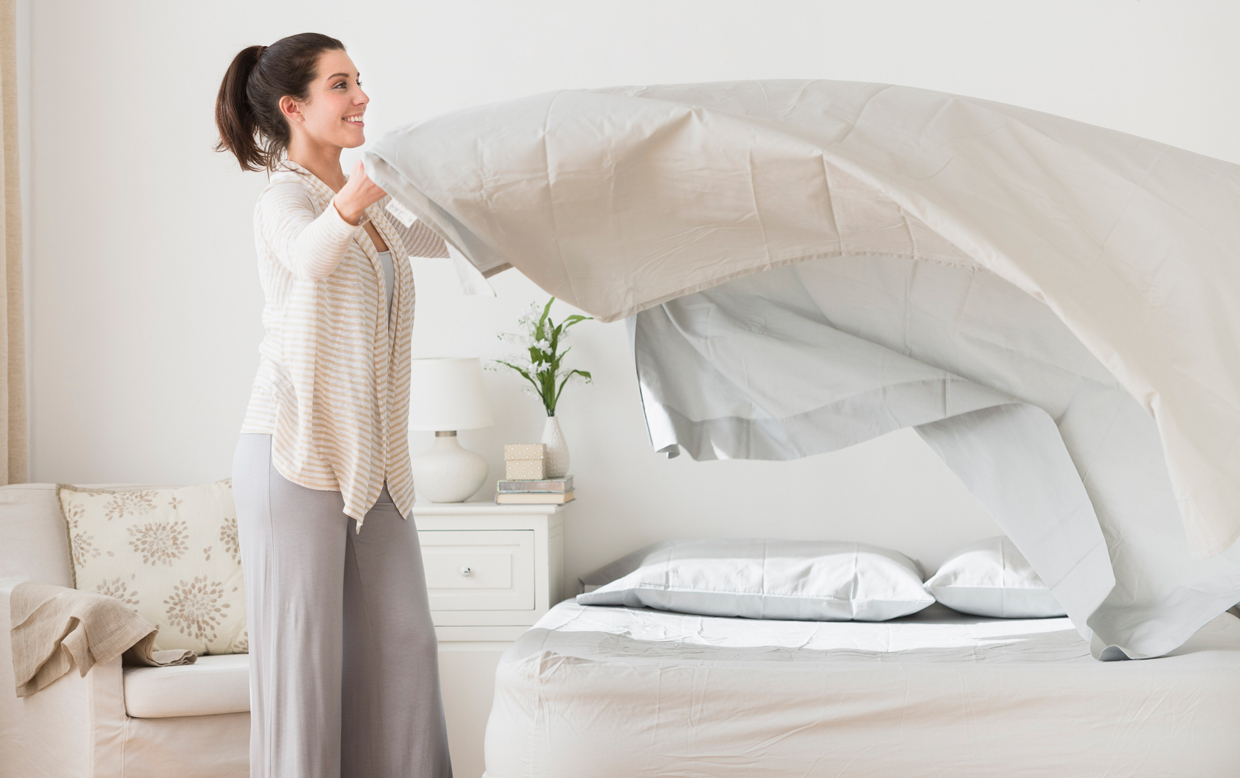 woman setting up bed