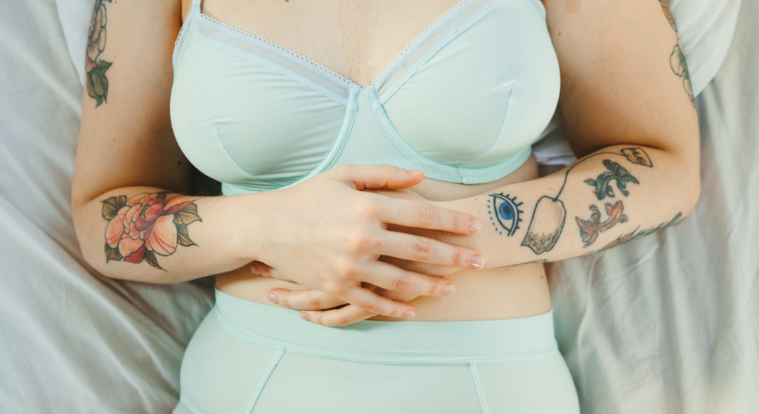 woman with tattoos wearing mint underwear