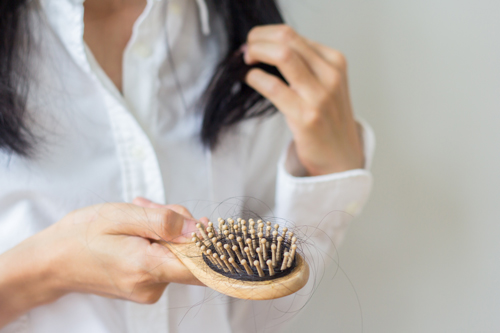 close up of a Woman Holding Hairbrush