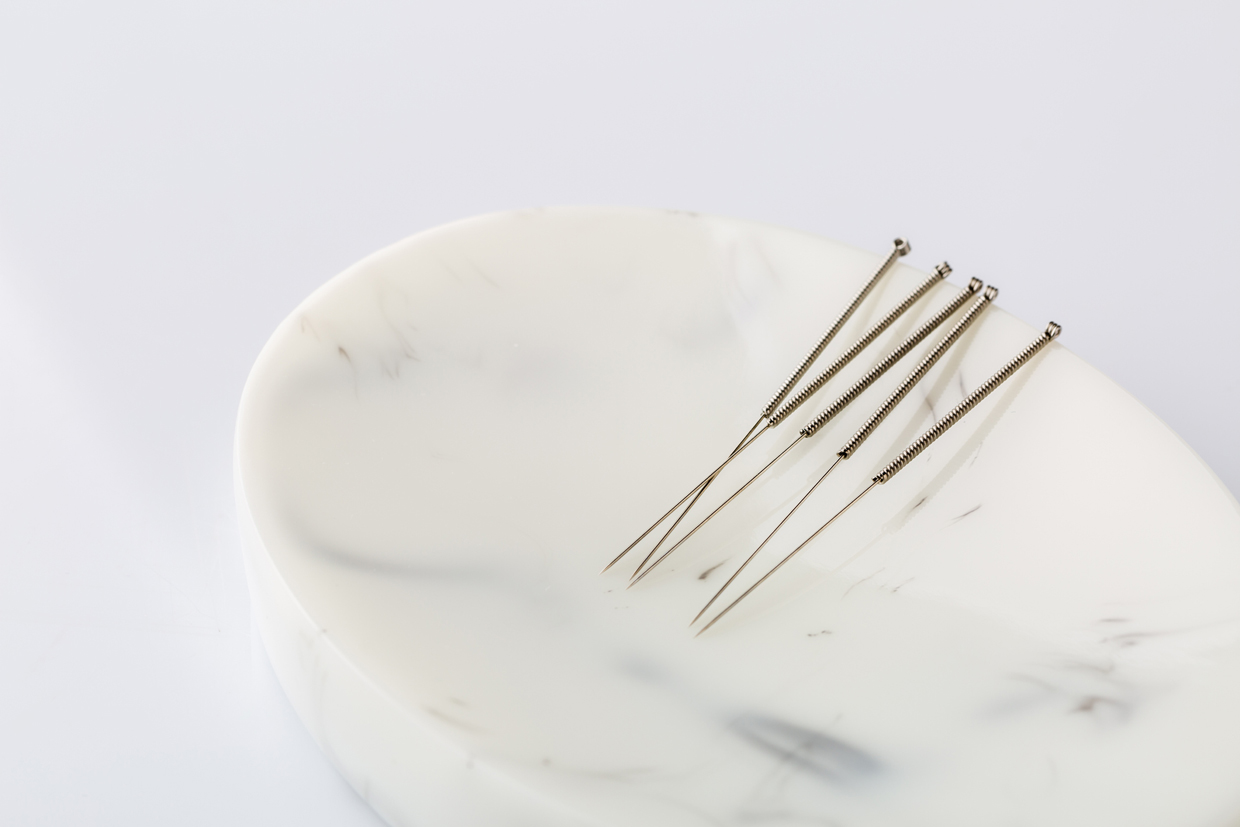 Acupuncture needles on the white marble