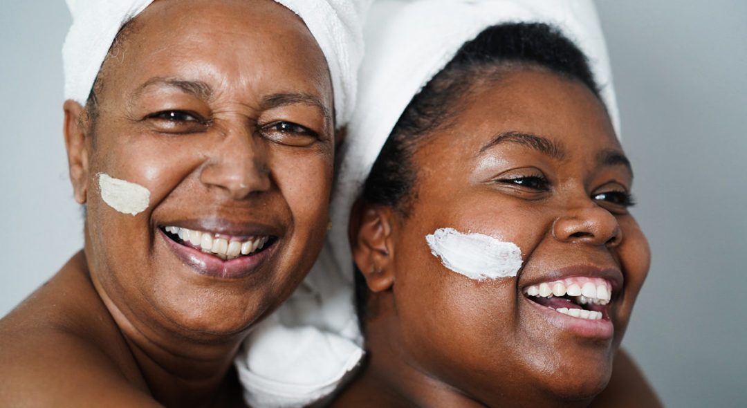 mother and daughter doing beauty treatment at home using skin mask