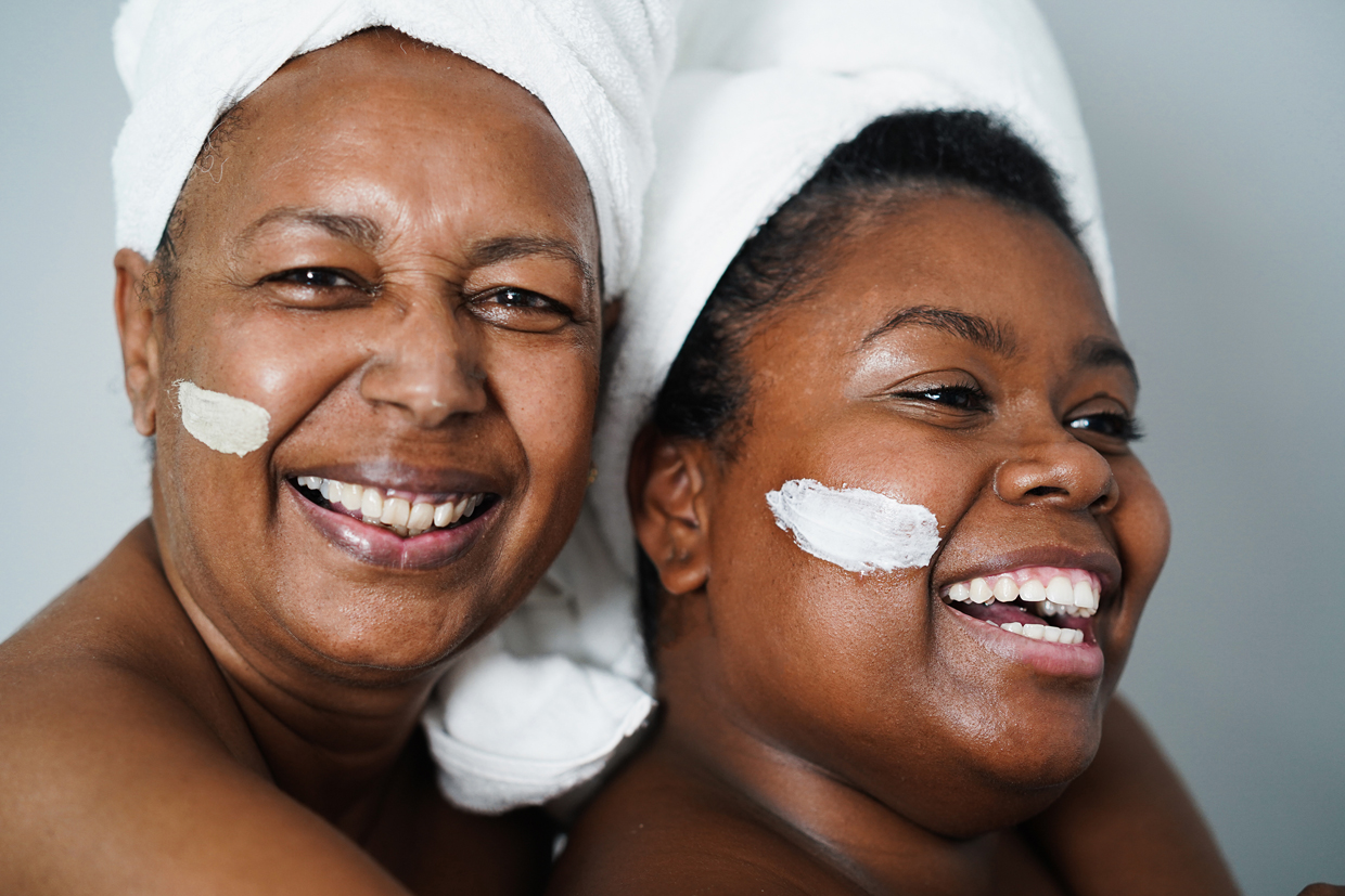 mother and daughter doing beauty treatment at home using skin mask