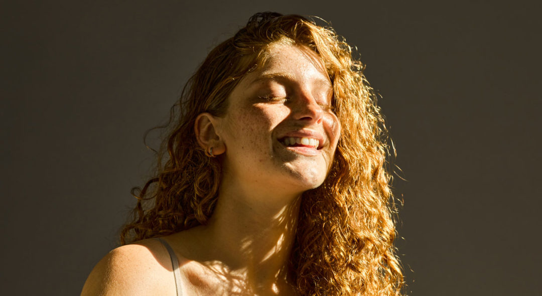 portrait of woman with sun in her face