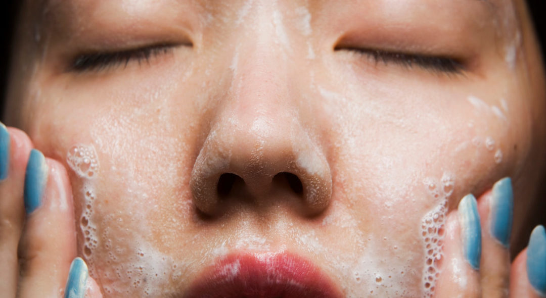 woman washing face, close-up