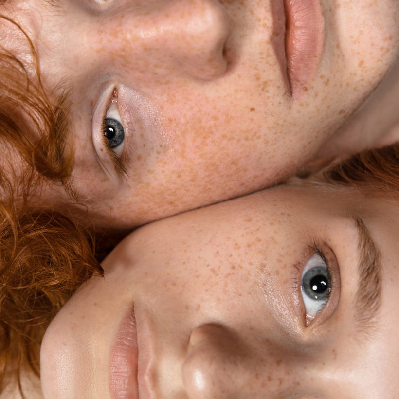 Portrait of two redheaded women isolated on grey studio background