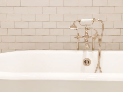 old-fashioned polished nickel cross handle bathtub faucet & handheld sprayer with white antique cast iron claw foot tub