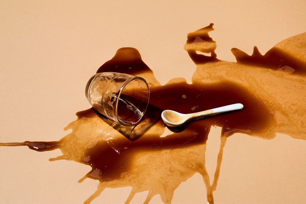 Spilled coffee on tan background