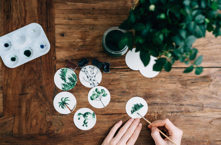 Cropped Hands Of Woman Doing Aquarelle At Wooden Table