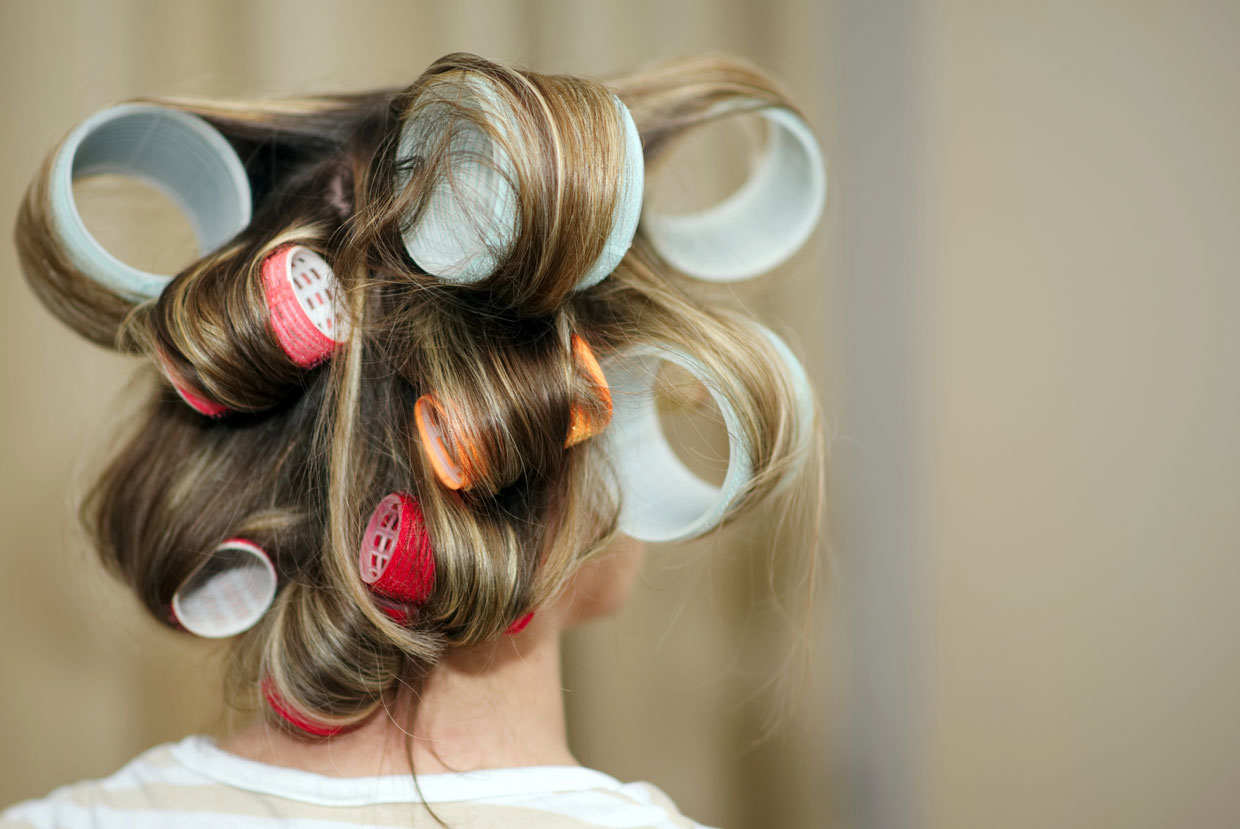 Rear View Of Woman With Hair Curlers