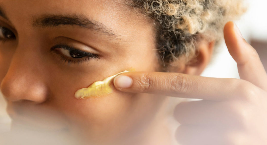 woman applying moisturizer