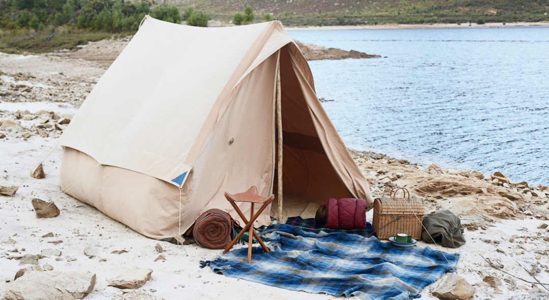 tent set up near a lake