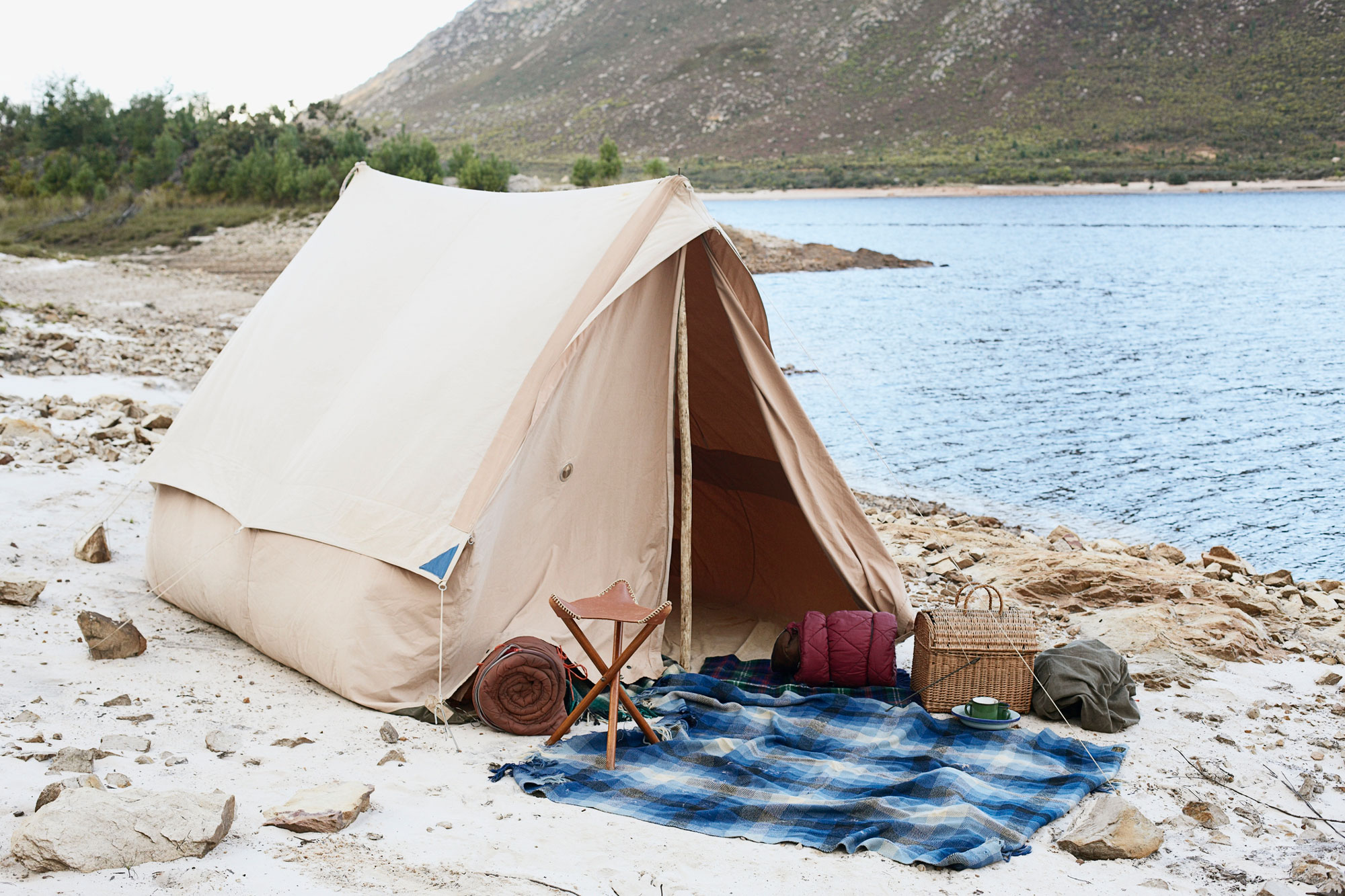 tent set up near a lake