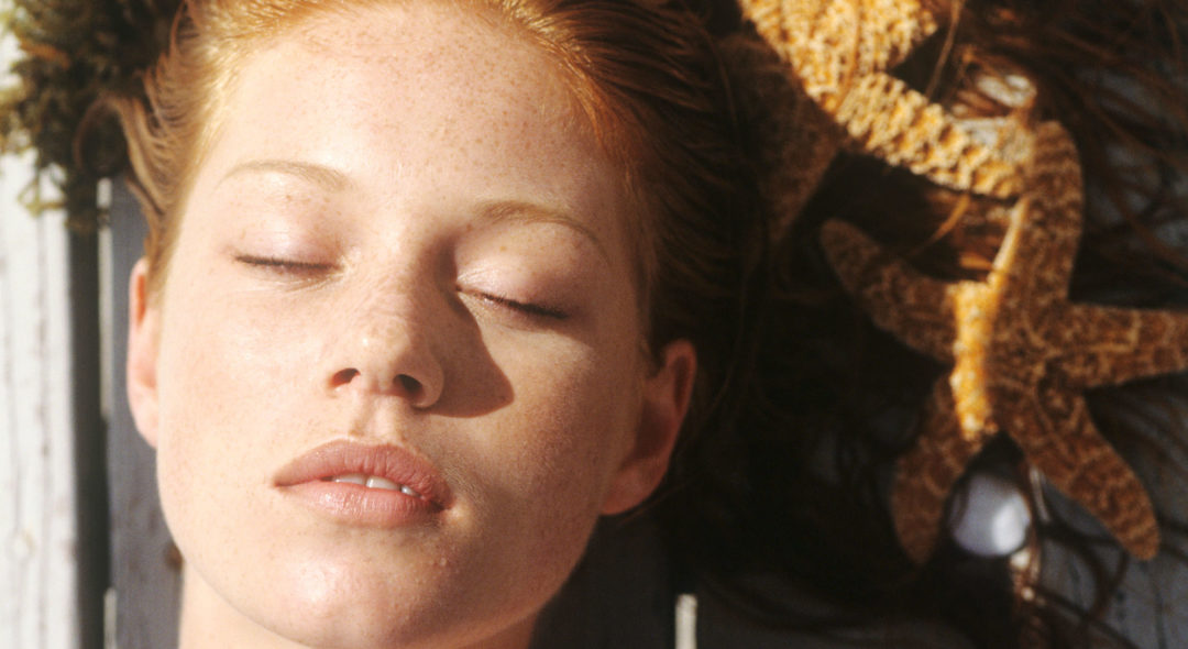 woman lying outdoors sunbathing