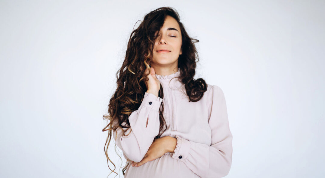 pregnant woman closed eyes on a white background