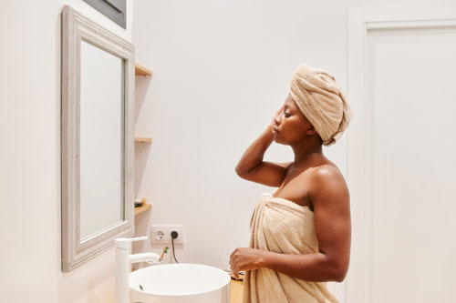 Pregnant woman wrapped in towels after showering