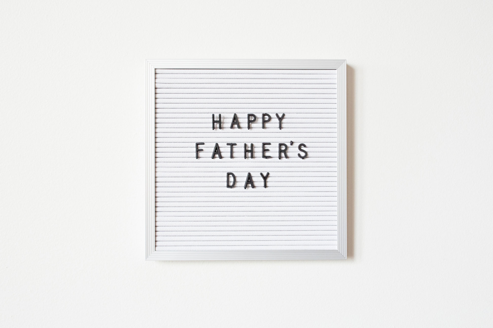 Happy Father's Day Letters and Words Spelled out on a Board
