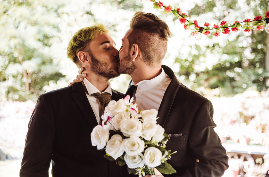 gay couple kissing at their wedding