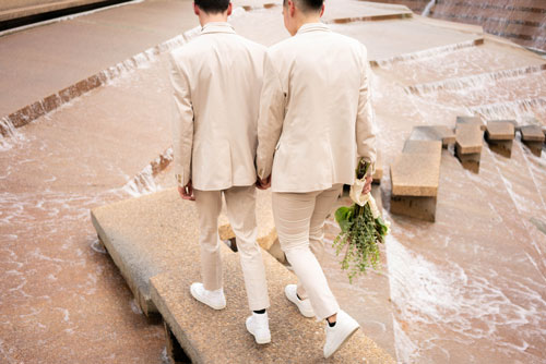 gay couple in suits getting marries