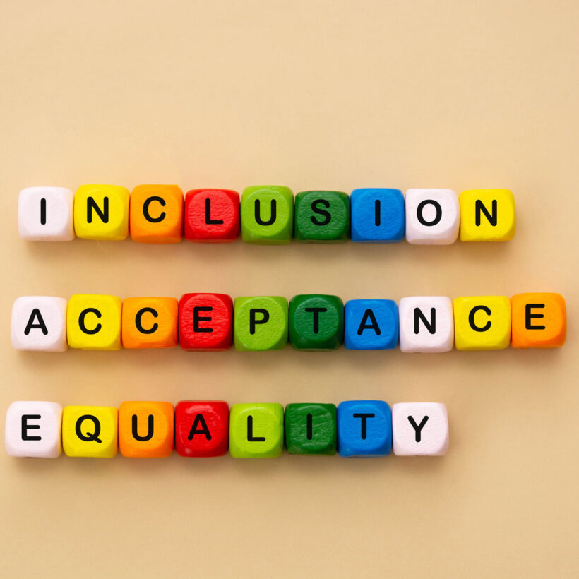 Inclusion, acceptance and equality words made from colorful wooden cubes