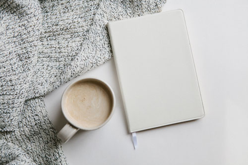 White Journal With Blanket and Coffee on White Background