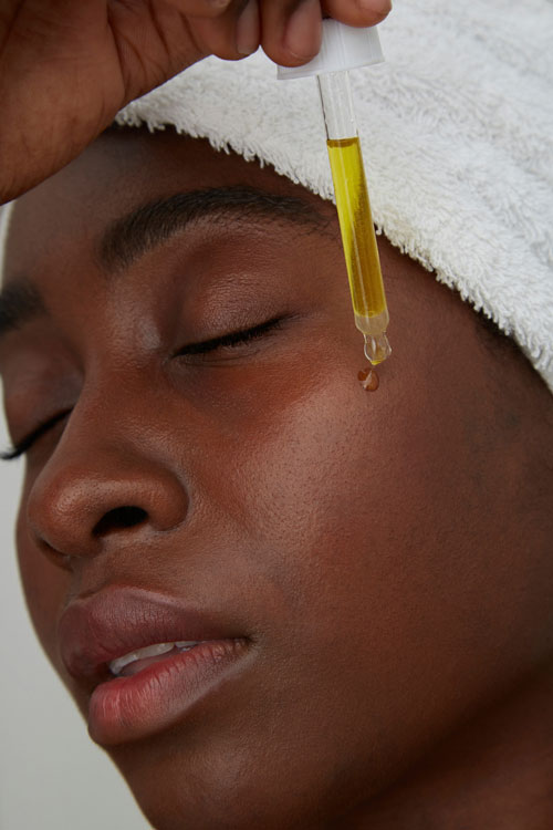 Portrait of woman using pipette