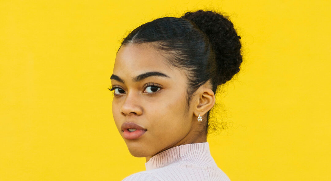 Portrait of teen posing in front of a yellow background