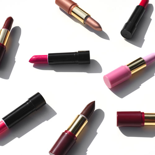 Multi-colored lipstick with shadow on a white background.