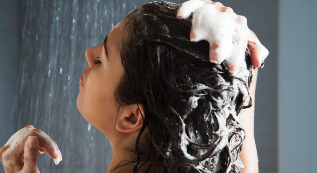 woman washing her hair in shower