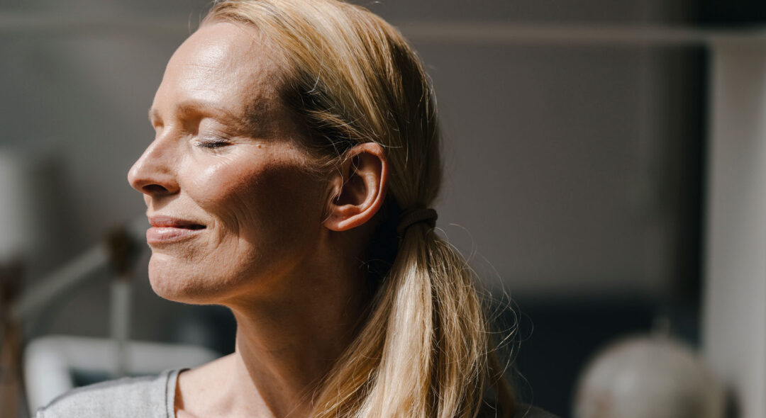 Portrait of smiling woman's face in sunlight