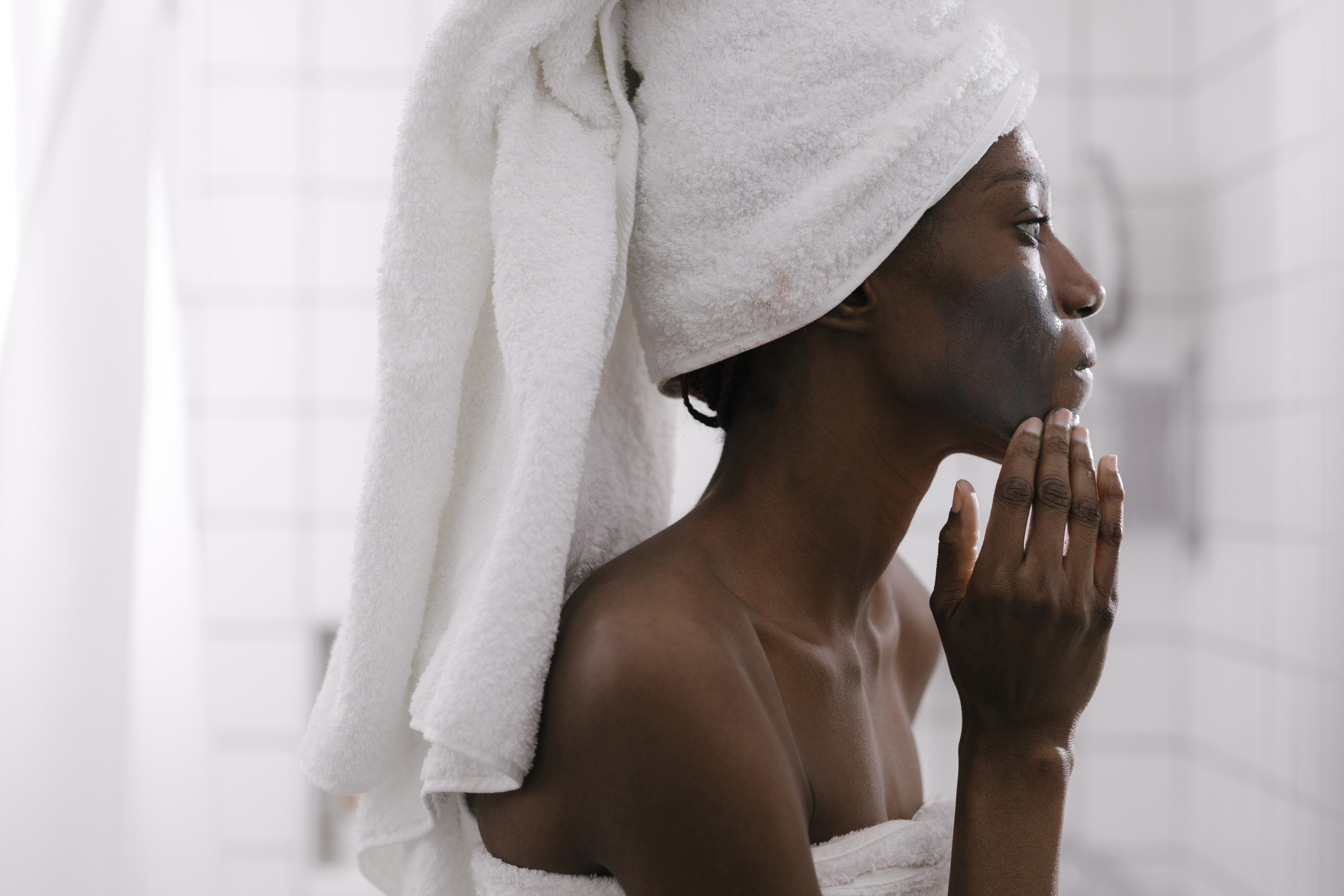 Woman Using Charcol Cosmetic Face Mask