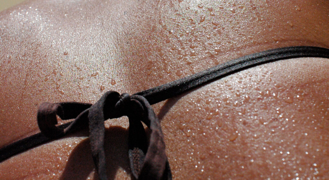 water droplets run down a woman's bare back