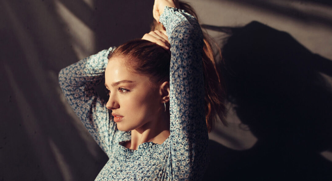 redhead woman tying hair
