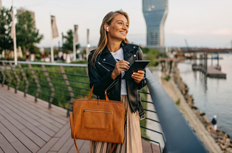 woman outside carrying bag
