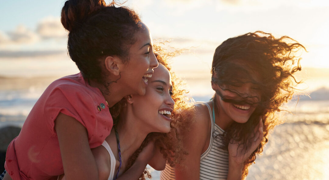 group of women laughing at the beach