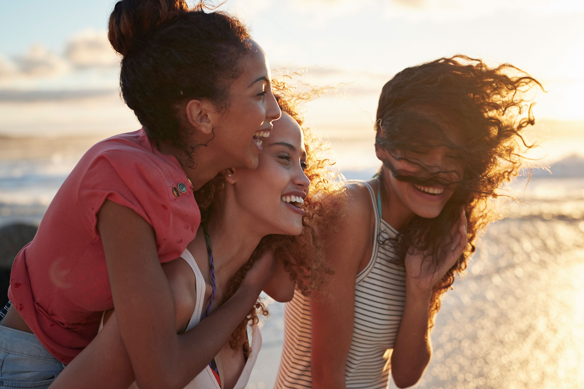 group of women laughing at the beach