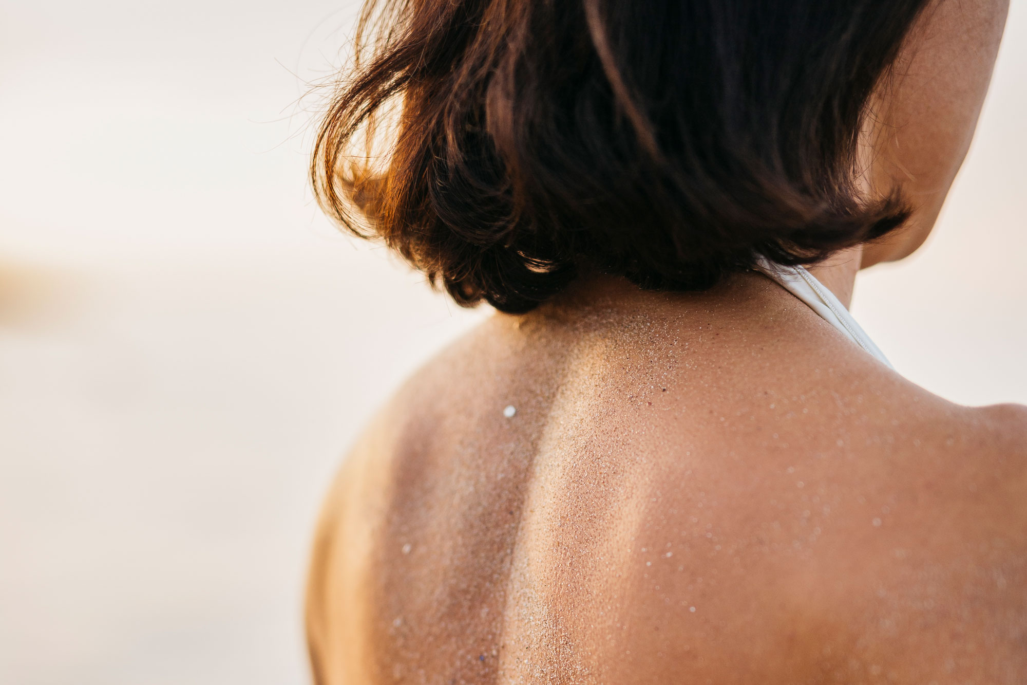 close up of woman's back at the beach