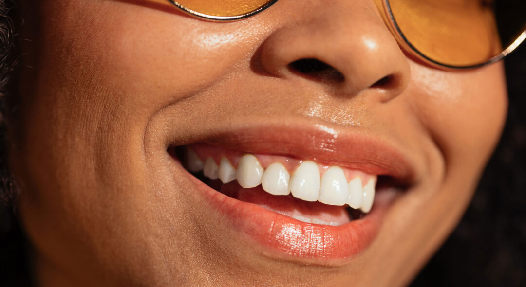 close up of woman with glasses smiling