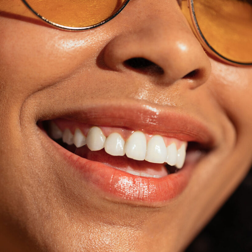 close up of woman with glasses smiling