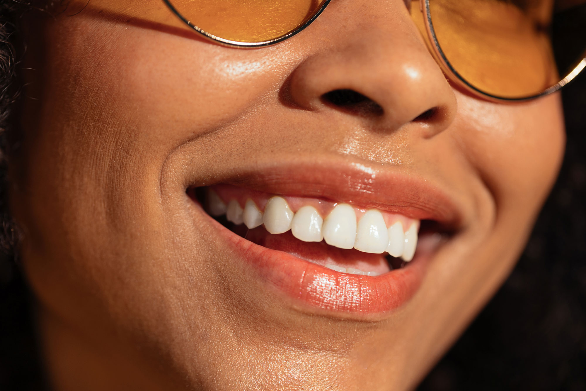 close up of woman with glasses smiling