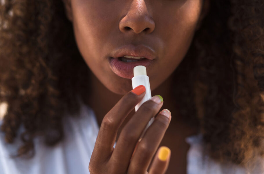 Woman applying lip balm