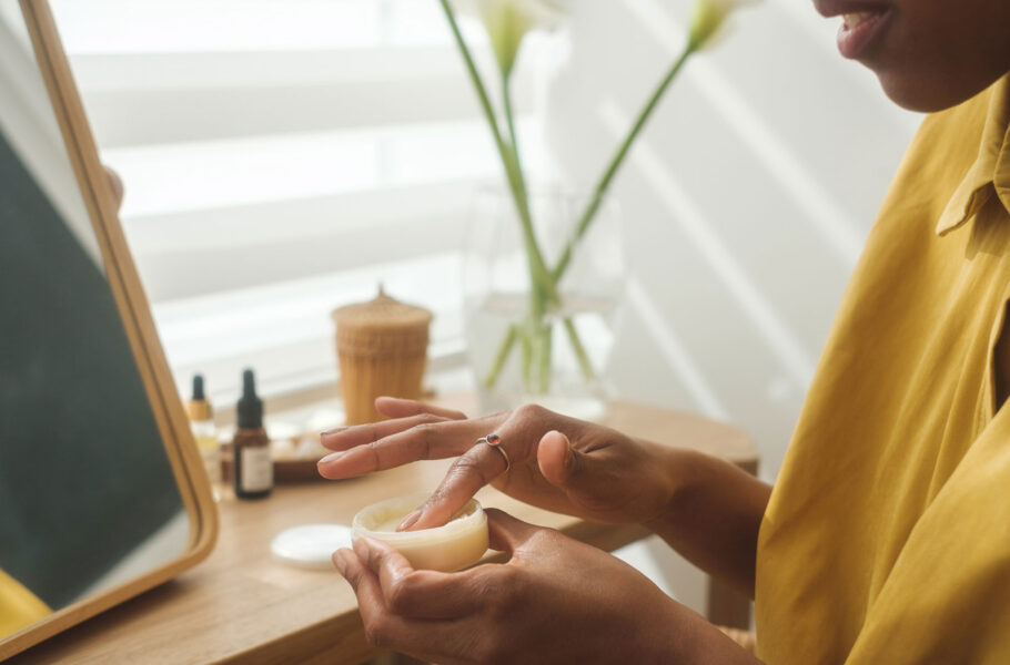 woman in vanity looking at skincare product